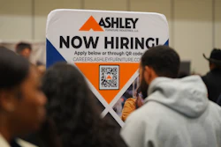 A sign with information about employment is displayed during a job fair in Dallas, Jan. 14, 2026.