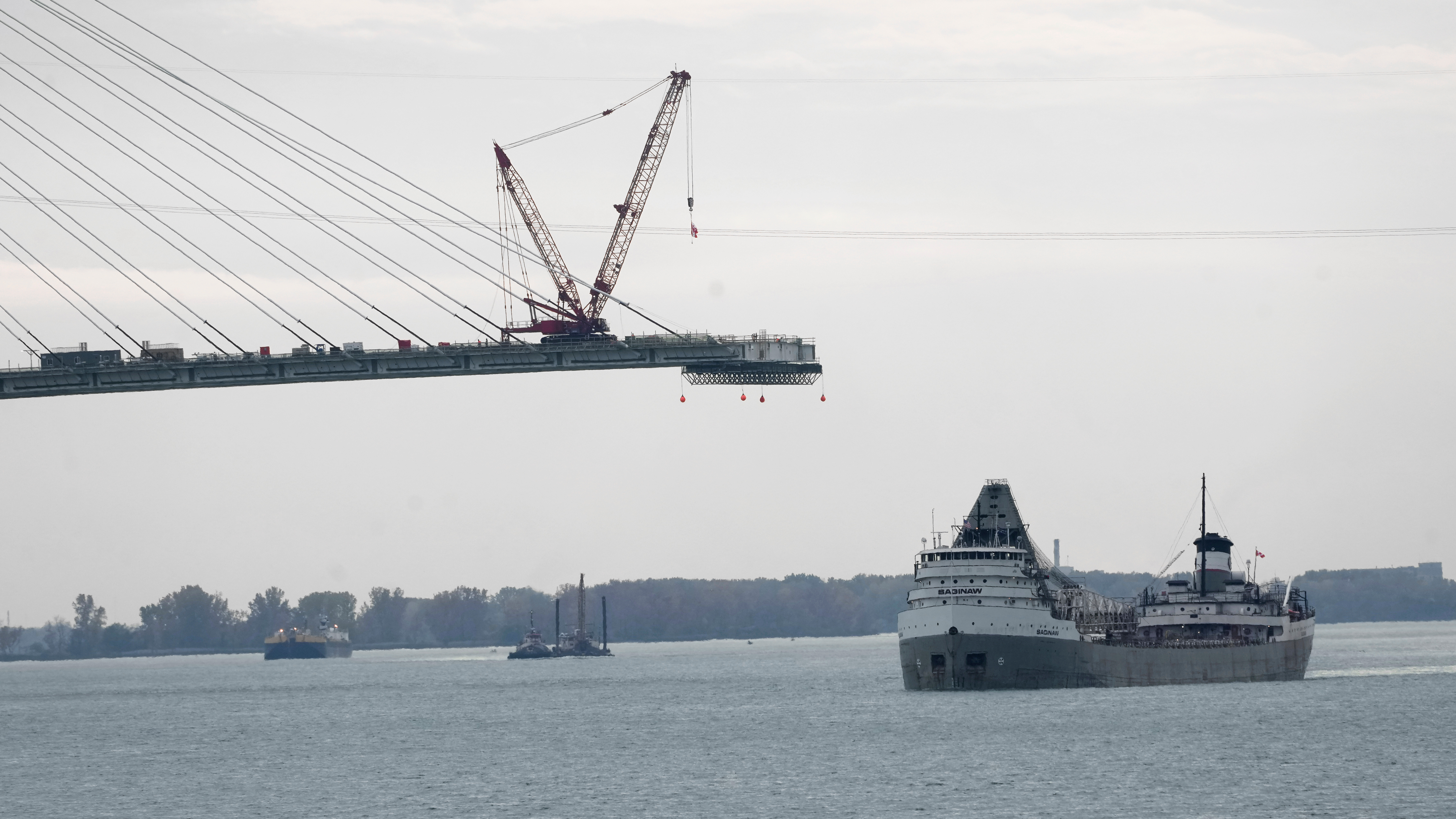 The Saginaw passes construction on the Gordie Howe International Bridge on the Detroit River, Oct. 25, 2023.