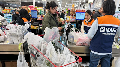 A shopper checks out in a grocery store in Schaumburg, Ill., Feb. 9, 2026.