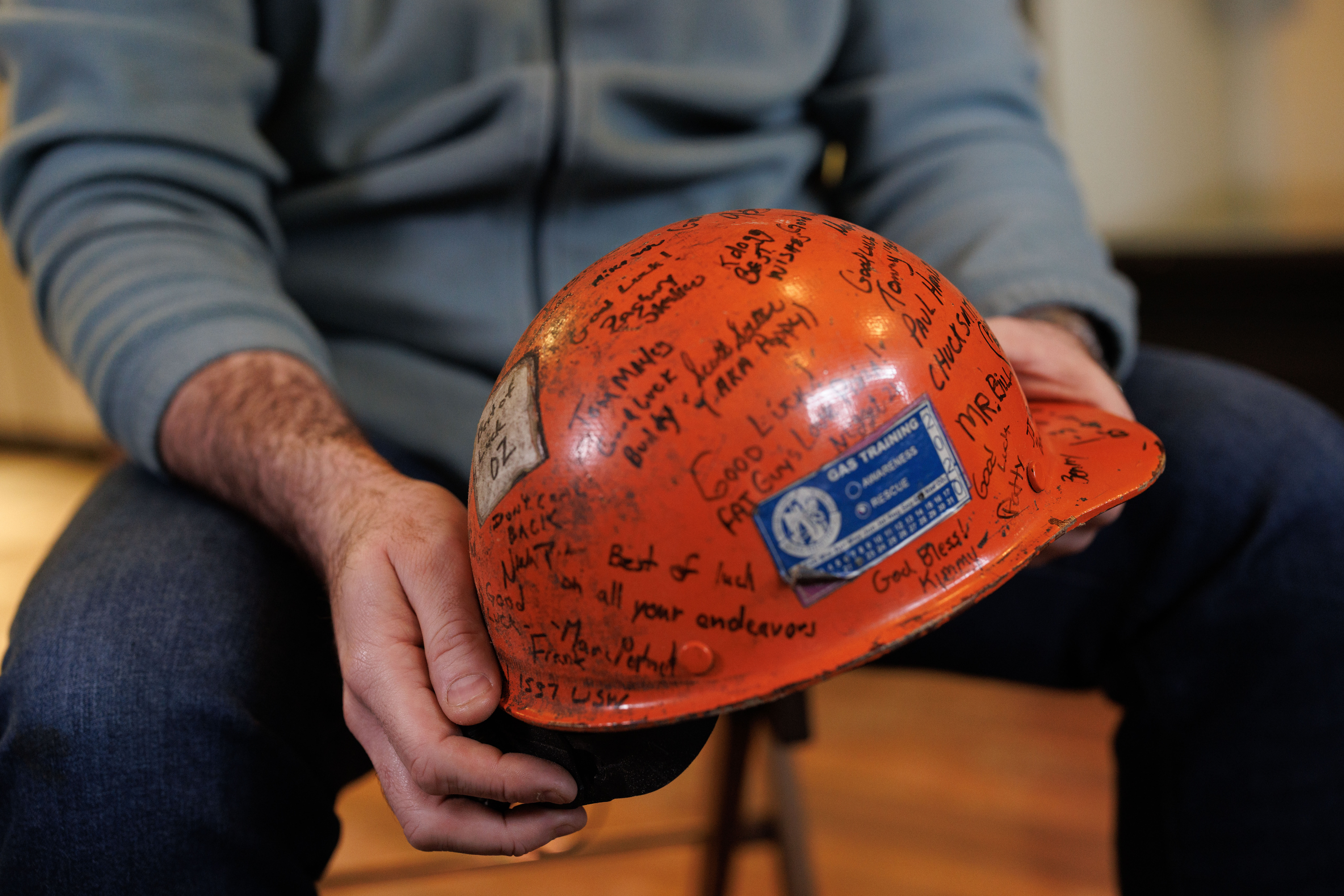 Former U.S. Steel worker Jonathan Ledwich holds his old hard hat at the pizza shop he now owns in Trafford, Pa., on Monday, Dec. 15, 2025.
