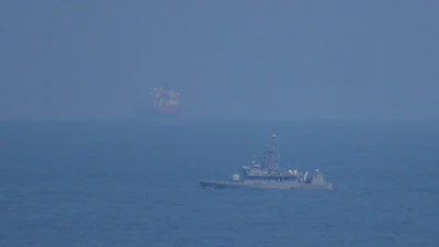 A UAE navy ship patrols the Strait of Hormuz as seen from Mina Al Fajer, United Arab Emirates, March 11, 2026.