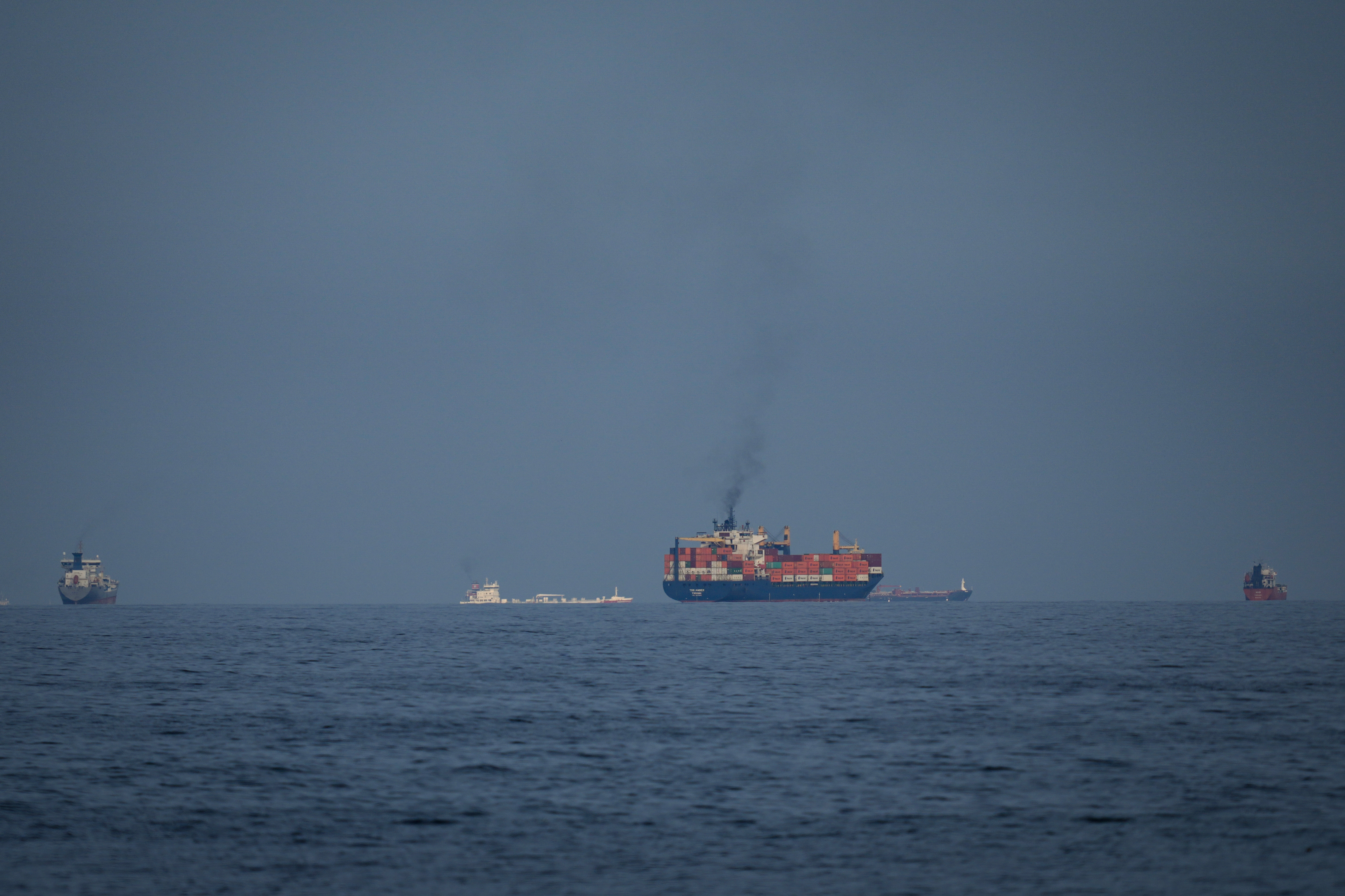 Oil tankers and cargo ships line up in the Strait of Hormuz as seen from Khor Fakkan, United Arab Emirates, March 11, 2026.