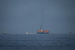 Oil tankers and cargo ships line up in the Strait of Hormuz as seen from Khor Fakkan, United Arab Emirates, March 11, 2026.
