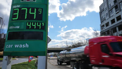 Fuel prices at a Baltimore gas station as a fuel truck drives by, March 17, 2026.