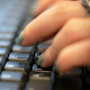 A person types on a computer keyboard in New York, Oct. 8, 2019.