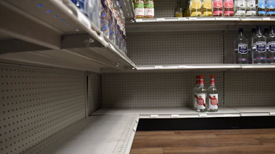 A shelf stands partially empty at Spillway Wine and Spirits in Brandon, Miss., April 16, 2026.