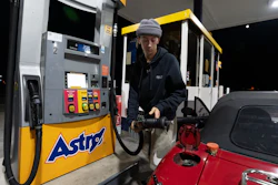 Luciano V. replaces the fuel nozzel after filling the tank of their 1999 Mazda Miata at an Astro gas station on Wednesday, April 29, 2026, in Portland, Ore.
