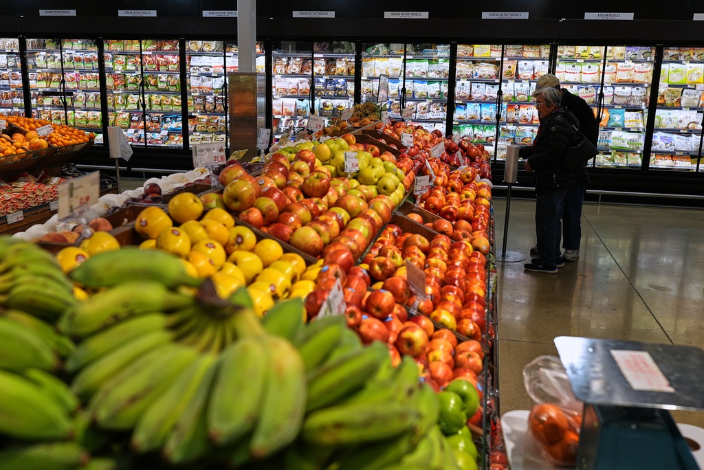 People shop at a grocery store, in Schaumburg, Ill., Thursday, April 2, 2026.