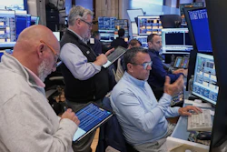 Robert Finnerty Jr., foreground right, works with colleagues on the floor of the New York Stock Exchange, May 7, 2026.