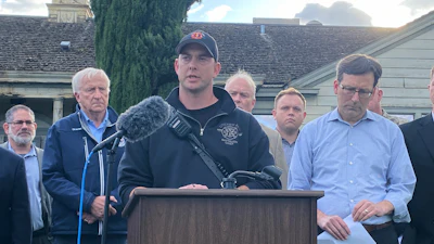 Longview Fire Department Battalion Chief Matt Amos speaks at a press conference in Longview, Wash., Tuesday, May 26, 2026, at the site of a paper mill where a chemical tank failure killed at least one person and left others unaccounted for.