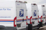 USPS delivery vans in Denver, March 23, 2026.