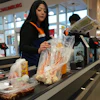 A employee works at a cash register in a grocery store in Schaumburg, Ill., May 14, 2026.