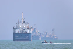 A motorboat passes anchored vessels in the Strait of Hormuz off Bandar Abbas, Iran, June 11, 2026.