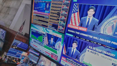 Federal Reserve Chair Kevin Warsh's press conference appears on screens on the floor of the New York Stock Exchange, June 17, 2026.