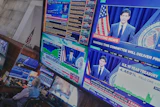 Federal Reserve Chair Kevin Warsh's press conference appears on screens on the floor of the New York Stock Exchange, June 17, 2026.