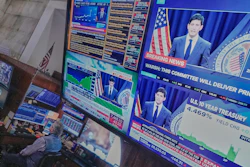 Federal Reserve Chair Kevin Warsh's press conference appears on screens on the floor of the New York Stock Exchange, June 17, 2026.