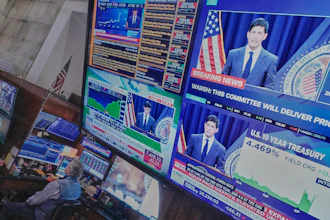 Federal Reserve Chair Kevin Warsh's press conference appears on screens on the floor of the New York Stock Exchange, June 17, 2026.