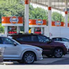 Cars line up at the pumps of a Gulf Oil station on the Massachusetts Turnpike near Boston, July 19, 2026.
