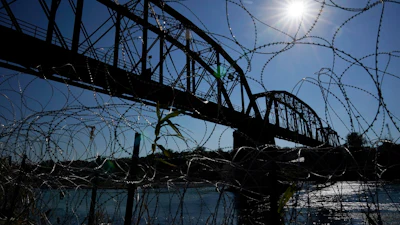The Union Pacific International Railroad Bridge is seen behind concertina wire, Eagle Pass, Texas, Sept. 22, 2023.