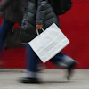 A person carries a shopping bag in Philadelphia, Dec. 10, 2025.