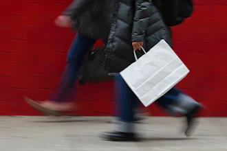 A person carries a shopping bag in Philadelphia, Dec. 10, 2025.