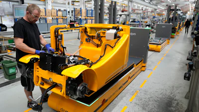 Employees at forklift and warehouse vehicle manufacturer Jungheinrich work on the assembly line in Moosburg, Germany, Aug. 25, 2026.