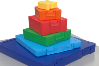 Colorful stacking toy blocks arranged in pyramid formation on gray base platform