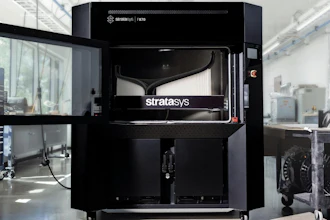 Stratasys F170 3D printer in industrial laboratory setting with white walls and equipment