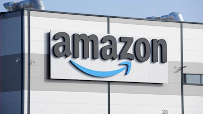 Amazon logo on industrial warehouse building exterior signage