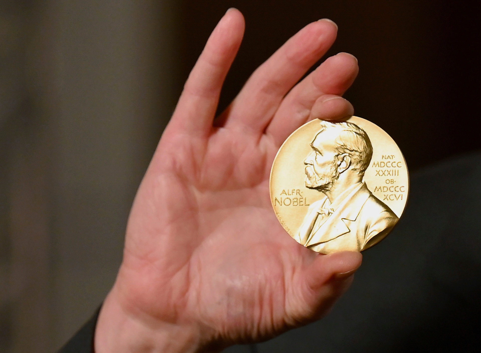 A Nobel medal is held up during a ceremony in New York, Dec. 8, 2020.