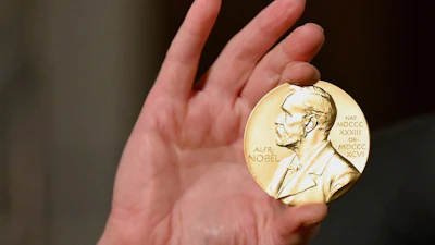 A Nobel medal is held up during a ceremony in New York, Dec. 8, 2020.