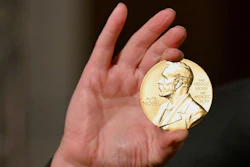 A Nobel medal is held up during a ceremony in New York, Dec. 8, 2020.