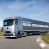 Mercedes-Benz fuel cell electric hydrogen-powered truck driving on highway with green landscape