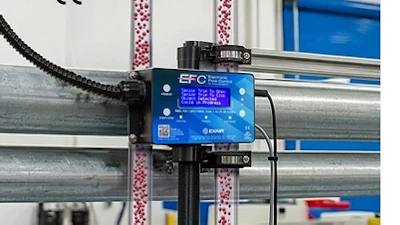 EFC blue control device mounted on industrial factory equipment with colorful overhead cables and structural beams