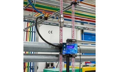 EFC blue control device mounted on industrial factory equipment with colorful overhead cables and structural beams