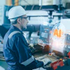 Industrial worker in hard hat using AR technology displaying AI analytics and data metrics on holographic display in manufacturing facility