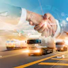 Global supply chain logistics: handshake with transportation network including trucks, planes, and shipping port operations.
