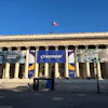 Classical building facade with Sonepar blue banner signage and columns under clear blue sky