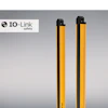 Two yellow and black IO-Link Safety light curtain sensors displayed against gradient background